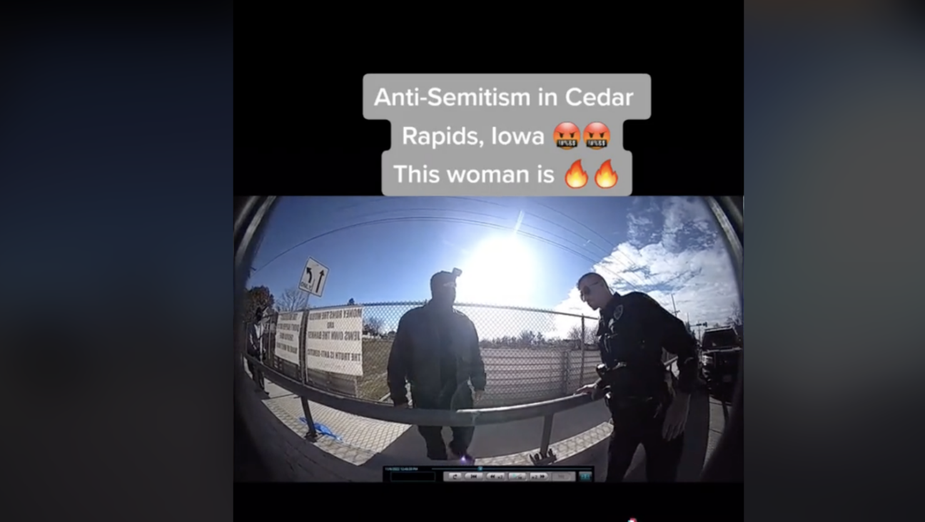 Police body camera footage of an incident involving men standing near antisemitic signs and a woman demanding they be taken down has gone viral on TikTok. 