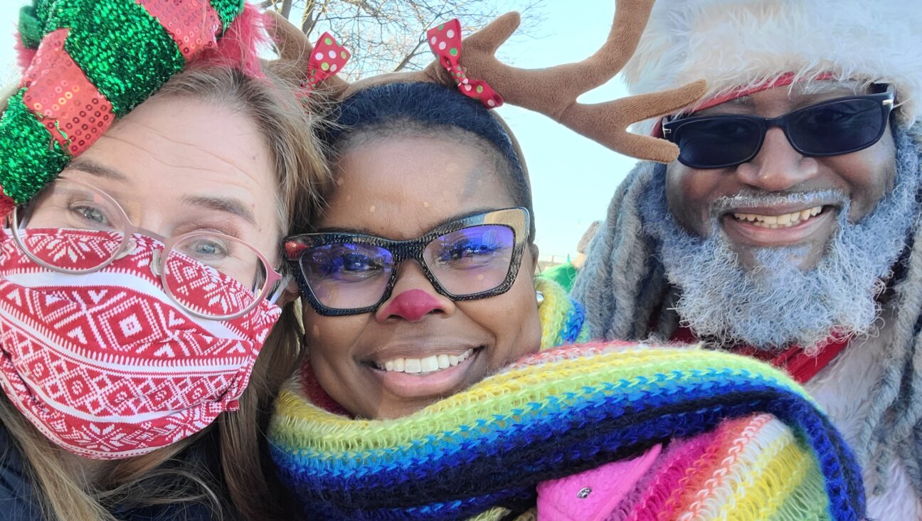 From left: Christmas Caravan participants Laura Frisch and Rabbi Tamar Manasseh, with  Dreezy Claus, Chicago's official Black Santa. 