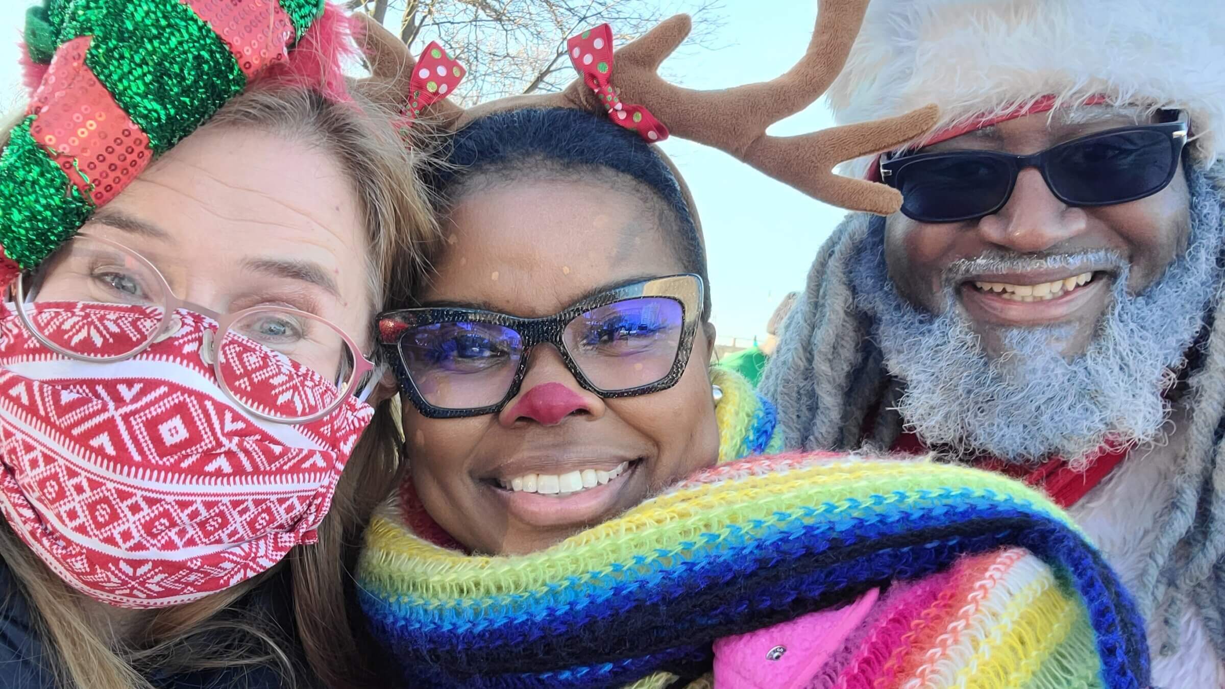 From left: Christmas Caravan participants Laura Frisch and Rabbi Tamar Manasseh, with  Dreezy Claus, Chicago's official Black Santa. 