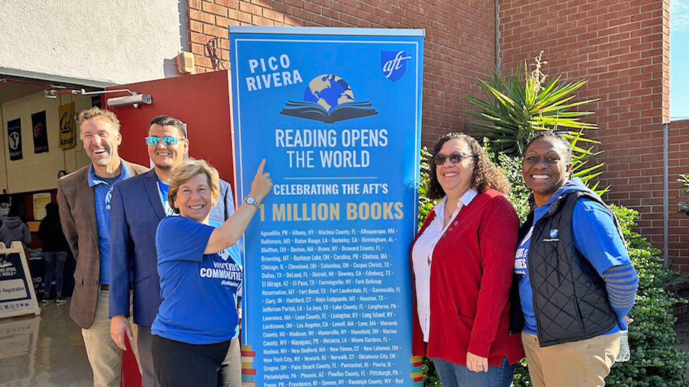 Weingarten, pointing, during an event on Dec. 10 in Pico Rivera, Calif., where the AFT donated the 1 millionth book through the union’s Reading Opens the World campaign.