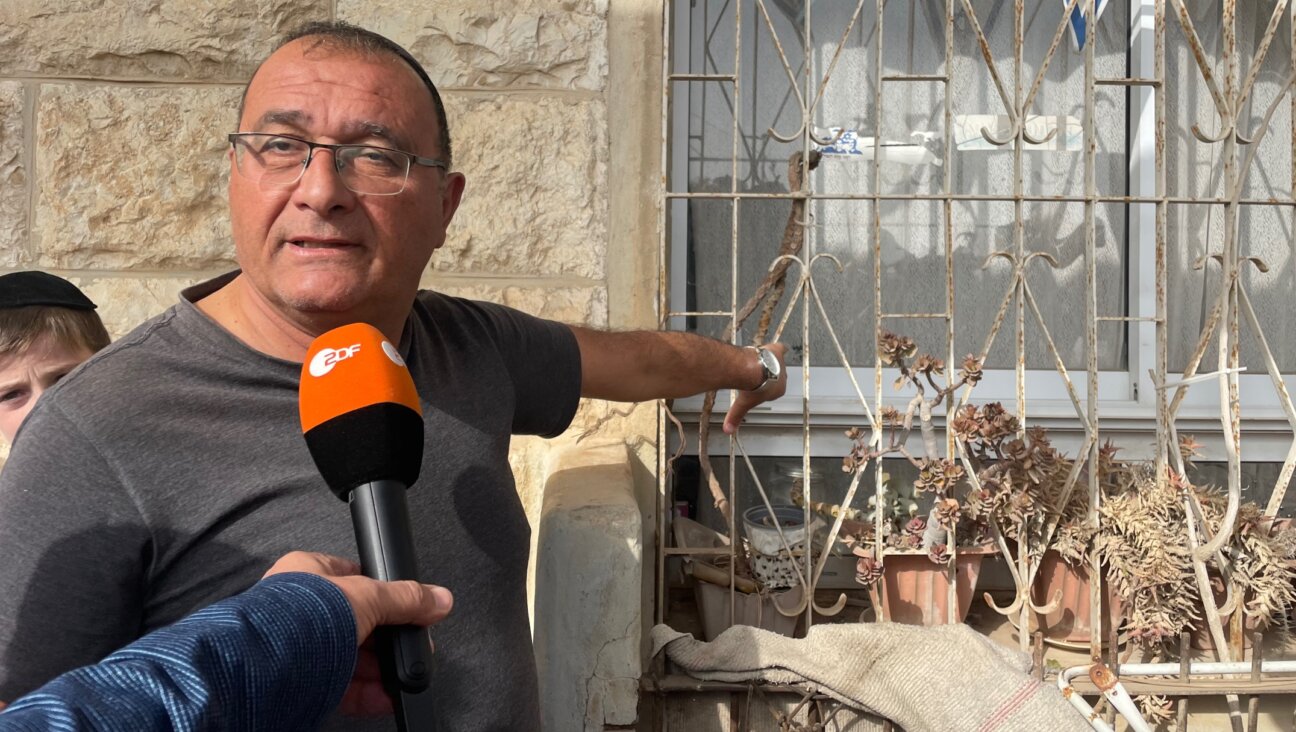 Shimon Yisrael points to where a gunman fired a bullet through his window in the neighborhood of Neve Yaakov, Jerusalem, Jan. 28, 2023. (Orly Halpern)