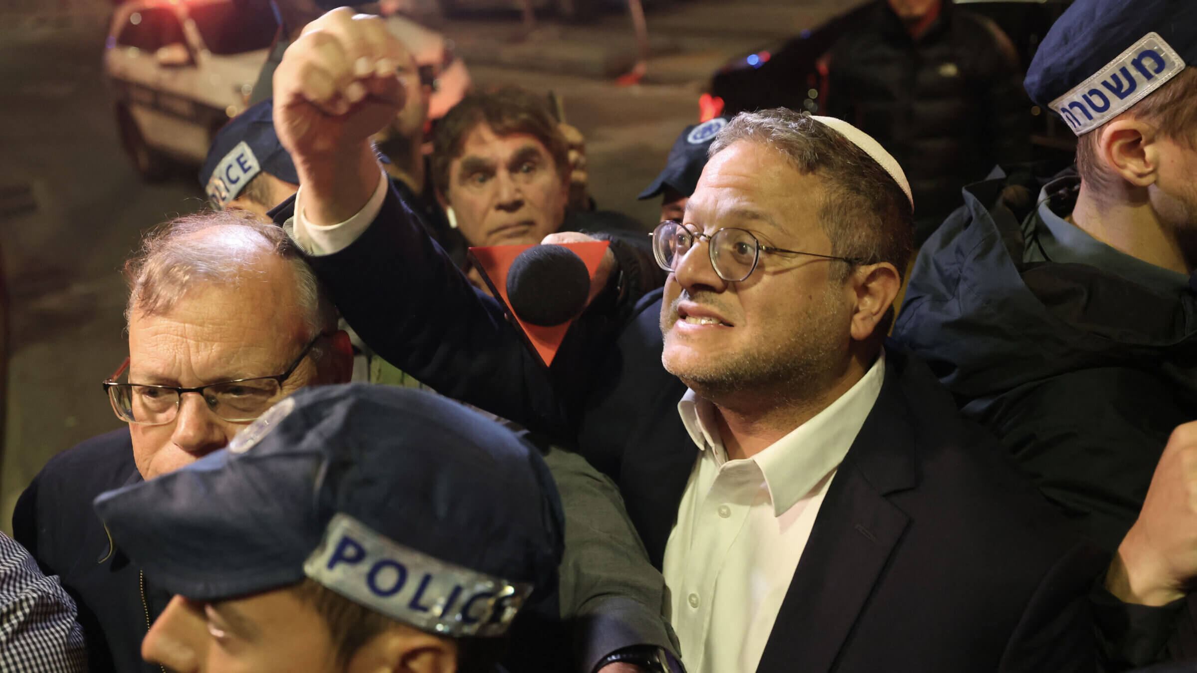 Israeli Minister of National Security Itamar Ben-Gvir speaks to bystanders as he walks to the site of a reported attack in a settler neighborhood in Israeli-annexed East Jerusalem on Jan. 27, 2023.