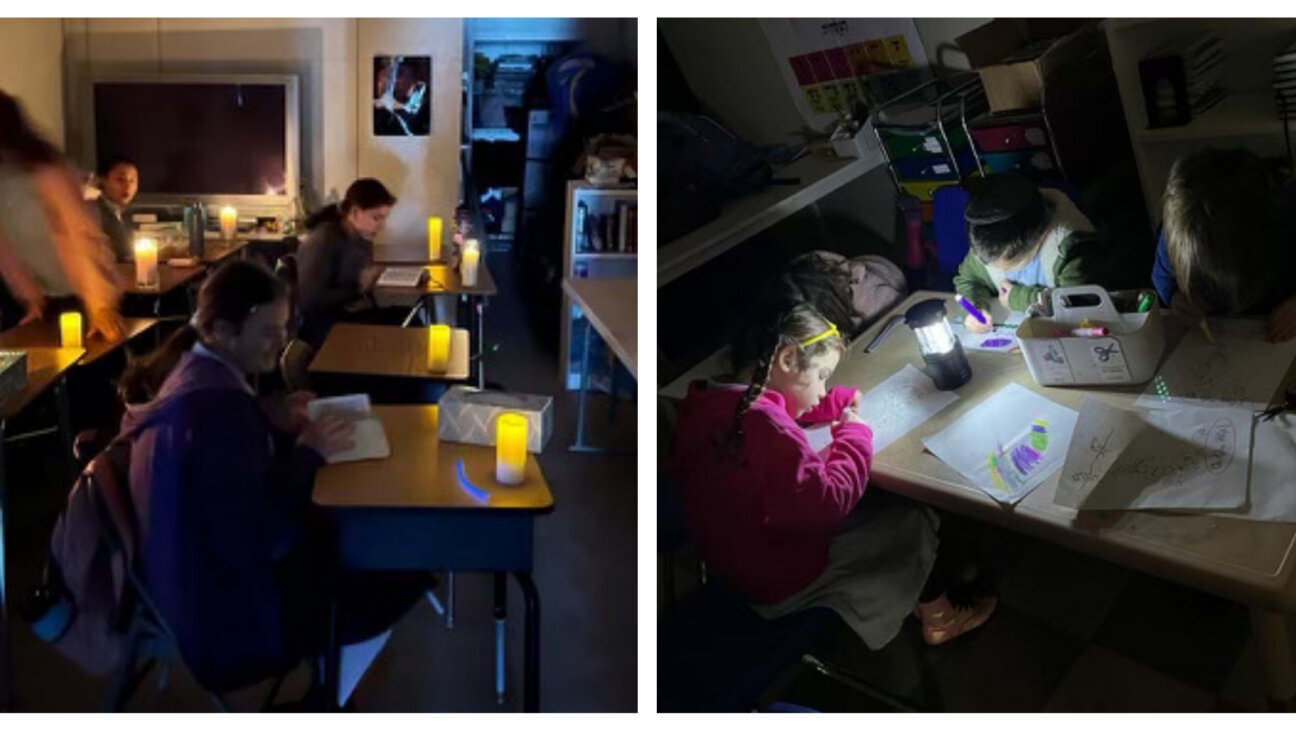 Cheder of the Bay Area students learn by candlelight during a power outage Wednesday.