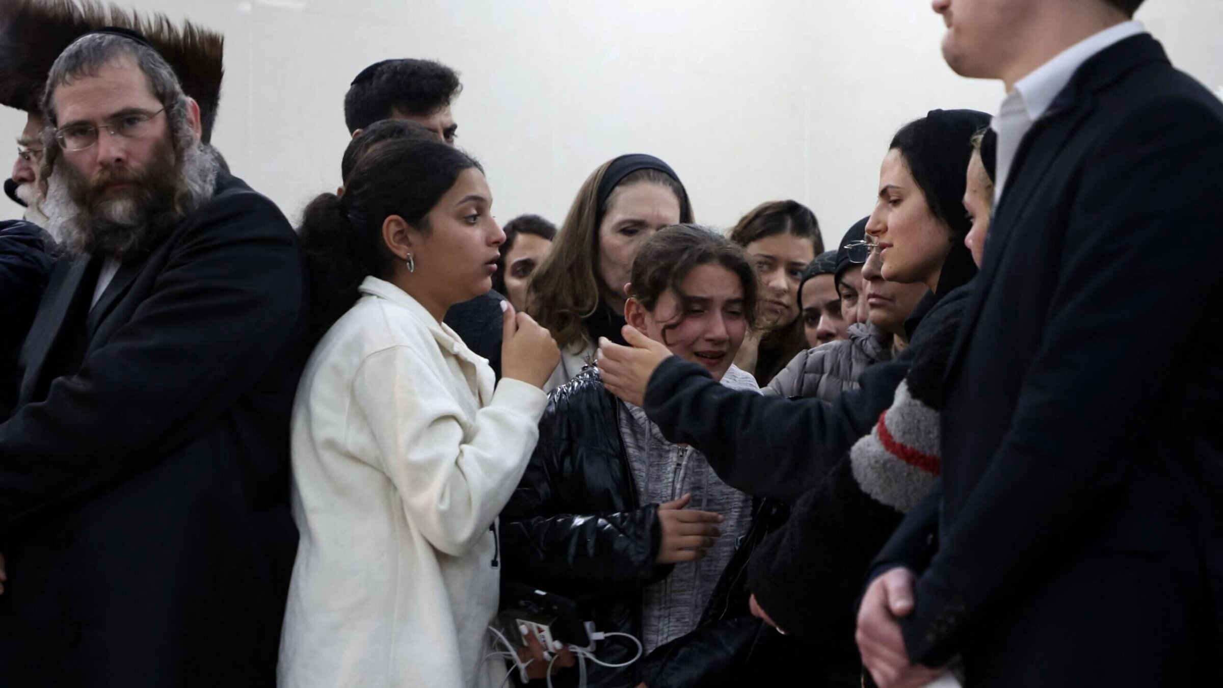 Relatives and friends mourn during the funeral of 14-year-old Asher Natan, a victim of the shooting attack in east Jerusalem.