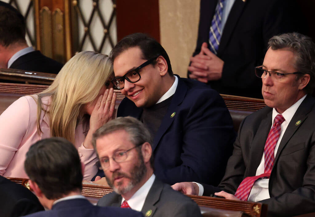 Rep. Marjorie Taylor Greene talks to Rep. George Santos on Jan. 5, 2023.