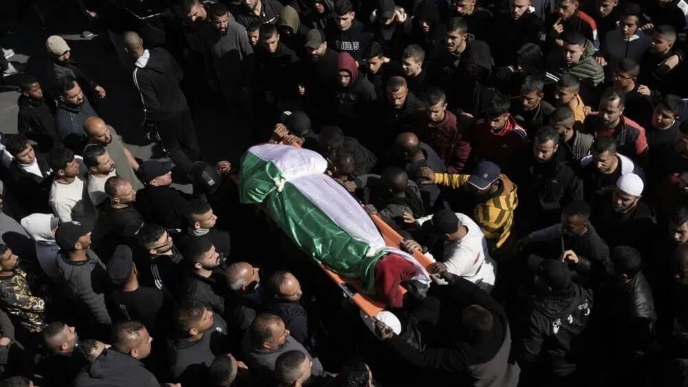 Mourners carry the body of a Palestinian woman, identified as Magda Obaid, 60, during her funeral in the West Bank city of Jenin, Thursday, Jan. 26, 2023. Palestinian health officials said Israeli forces killed at least nine Palestinians, including the Palestinian woman, and wounded several others during a raid in a flashpoint area of the occupied West Bank on Thursday, in one of the deadliest days in months of unrest. 