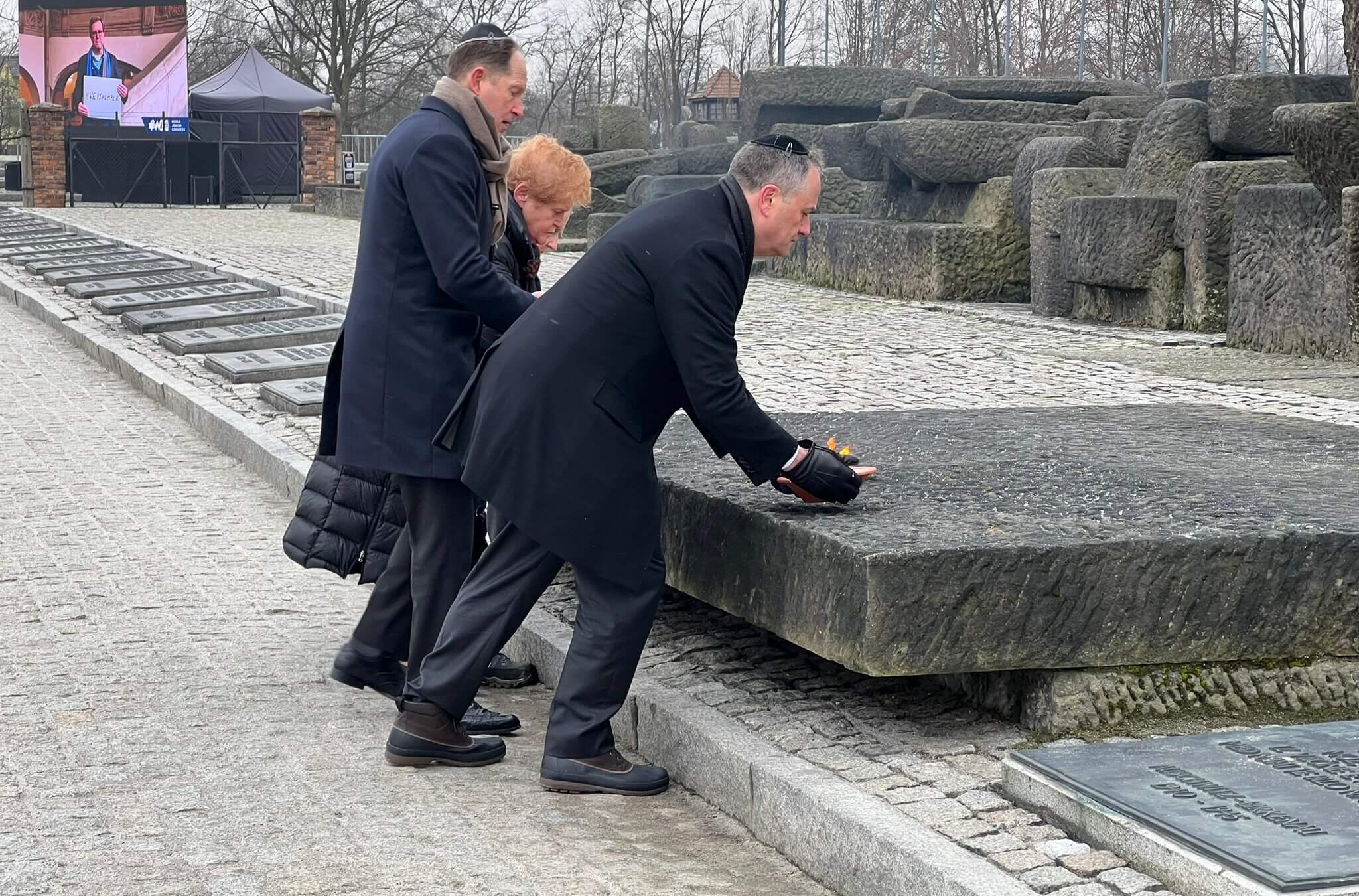 Ambassador Deborah Lipstadt, U.S. Ambassador to Poland Mark Brzezinski and Second Gentleman Doug Emhoff lay bowls of fire at a memorial in Birkenau.