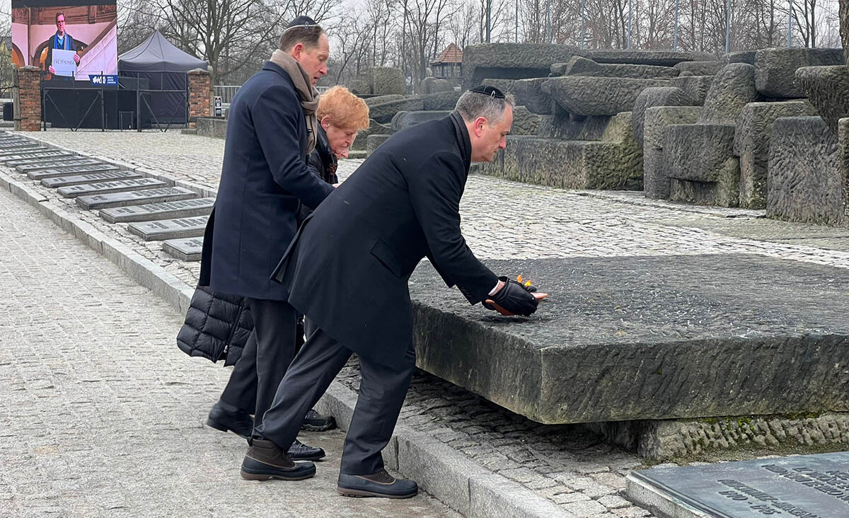 Ambassador Deborah Lipstadt, U.S. Ambassador to Poland Mark Brzezinski and second gentleman Doug Emhoff lay bowls of fire Friday morning at a memorial in Birkenau. (Laura E. Adkins)