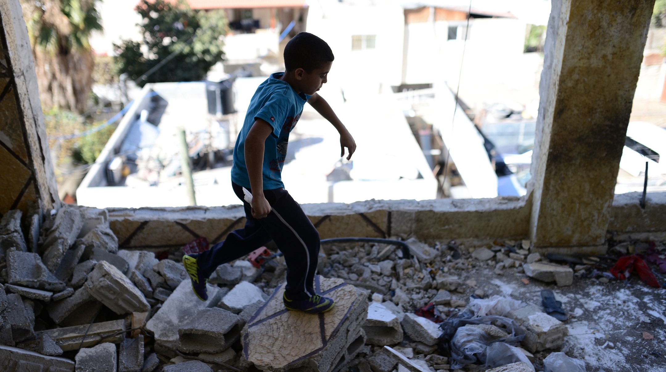 Relatives of Palestinian AbdelRahman al-Shaludi, blamed for killing two Israelis in a deadly vehicular attack last month, inspect the their family home after it was destroyed by Israeli forces in Silwan neighborhood, eastern Jerusalem on Nov. 19, 2014. (Salih Zeki Fazlioglu/Anadolu Agency/Getty Images)