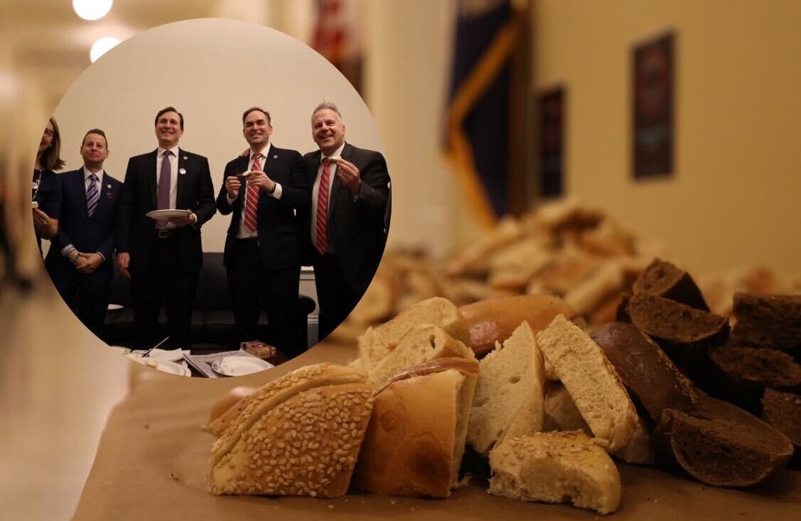 Rep. Daniel Goldman (center, with a plate) offered a spread of bagels to colleagues in Congress. 