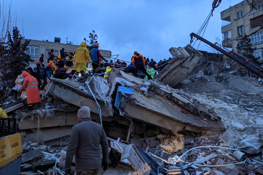 Rescue workers and volunteers search for survivors in the rubble of a collapsed building, in Sanliurfa, Turkey, on Feb. 6, 2023, after a 7.8-magnitude earthquake struck the country's southeast. 