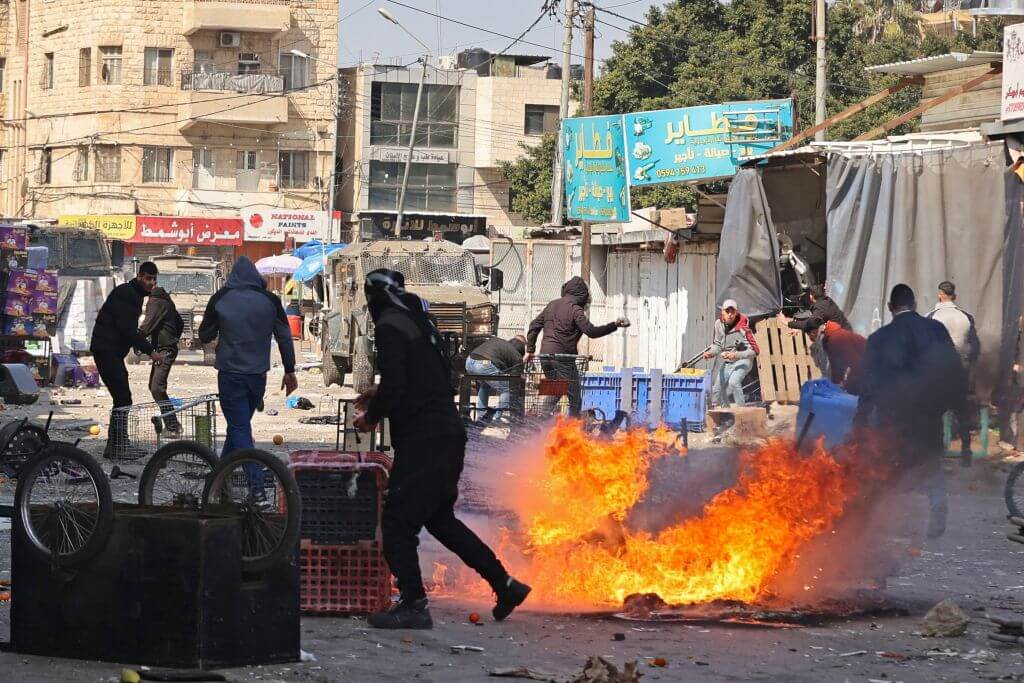 Palestinians clash with Israeli forces amid a raid in the occupied West Bank city of Nablus, on February 22, 2023.