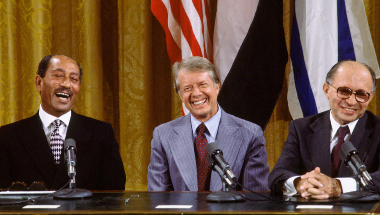 (L to R) Egyptian President Anwar al-Sadat, US President Jimmy Carter, and Israeli Premier Menachem Begin laugh together during the signing the Camp David Accords in the East Room of the White House, September 18, 1978, in Washington, DC. The agreement came after twelve days of secret negotiations at Camp David.