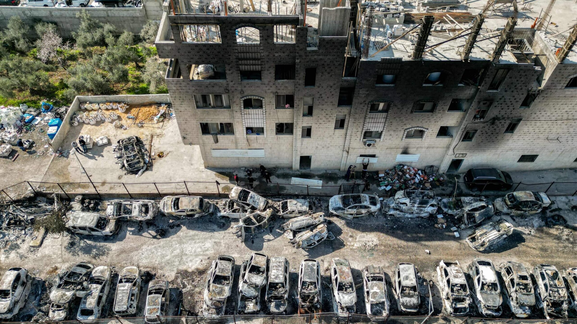 This picture taken on February 27, 2023 shows an aerial view of a scrapyard where cars were torched overnight, in the Palestinian town of Huwara near Nablus in the occupied West Bank. - Two Israelis living in the Har Bracha settlement near Nablus were killed on February 26 in a "Palestinian terror attack", officials said, sparking violence in which a Palestinian man was killed, while settlers torched homes in revenge. 