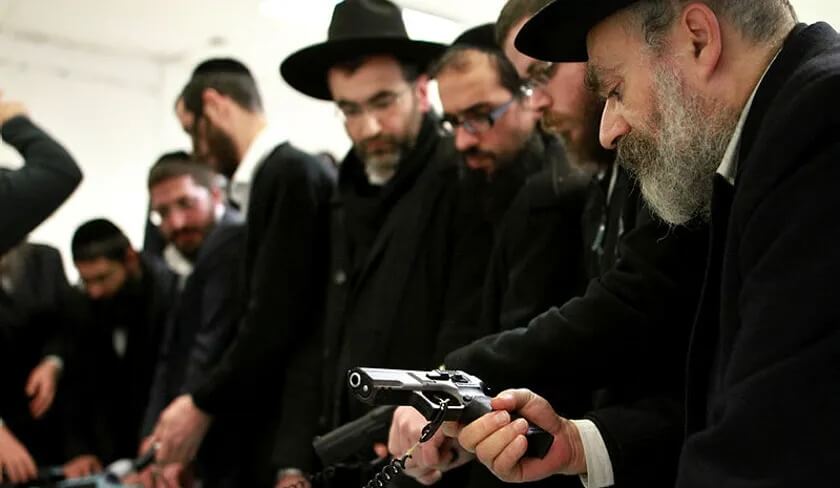 In Beitar Elit, Haredim test guns at a special fair for gun sales and licenses, in 2016.