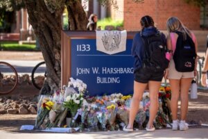  Students grieve by a memorial for Thomas Meixner, a professor at the University of Arizona. (Getty)