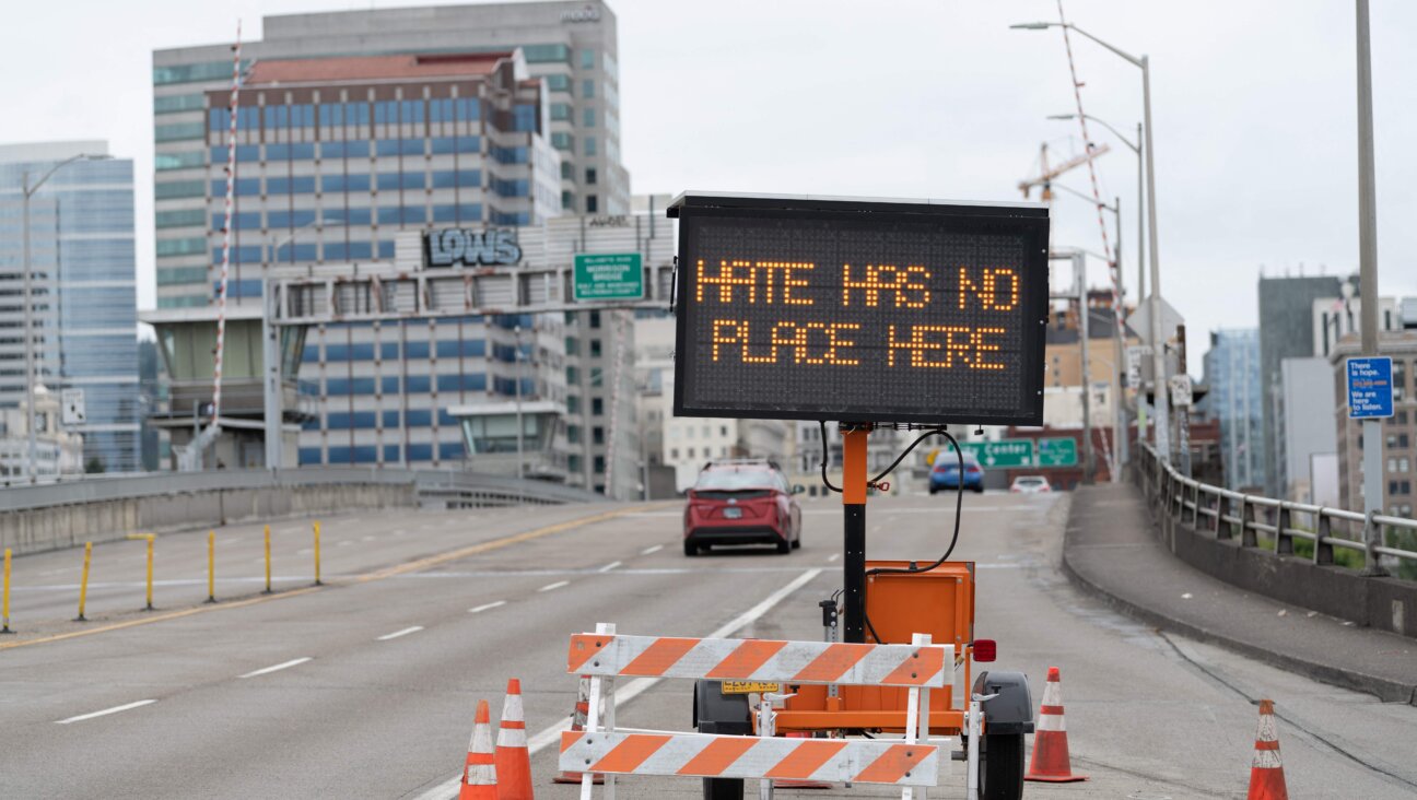 A traffic sign displays a message on a bridge in Portland, Oregon, in 2021 ahead of a far-right demonstration in the city. The Anti-Defamation League found that incidents of white supremacist propaganda more than doubled in 2022 compared to the previous year.