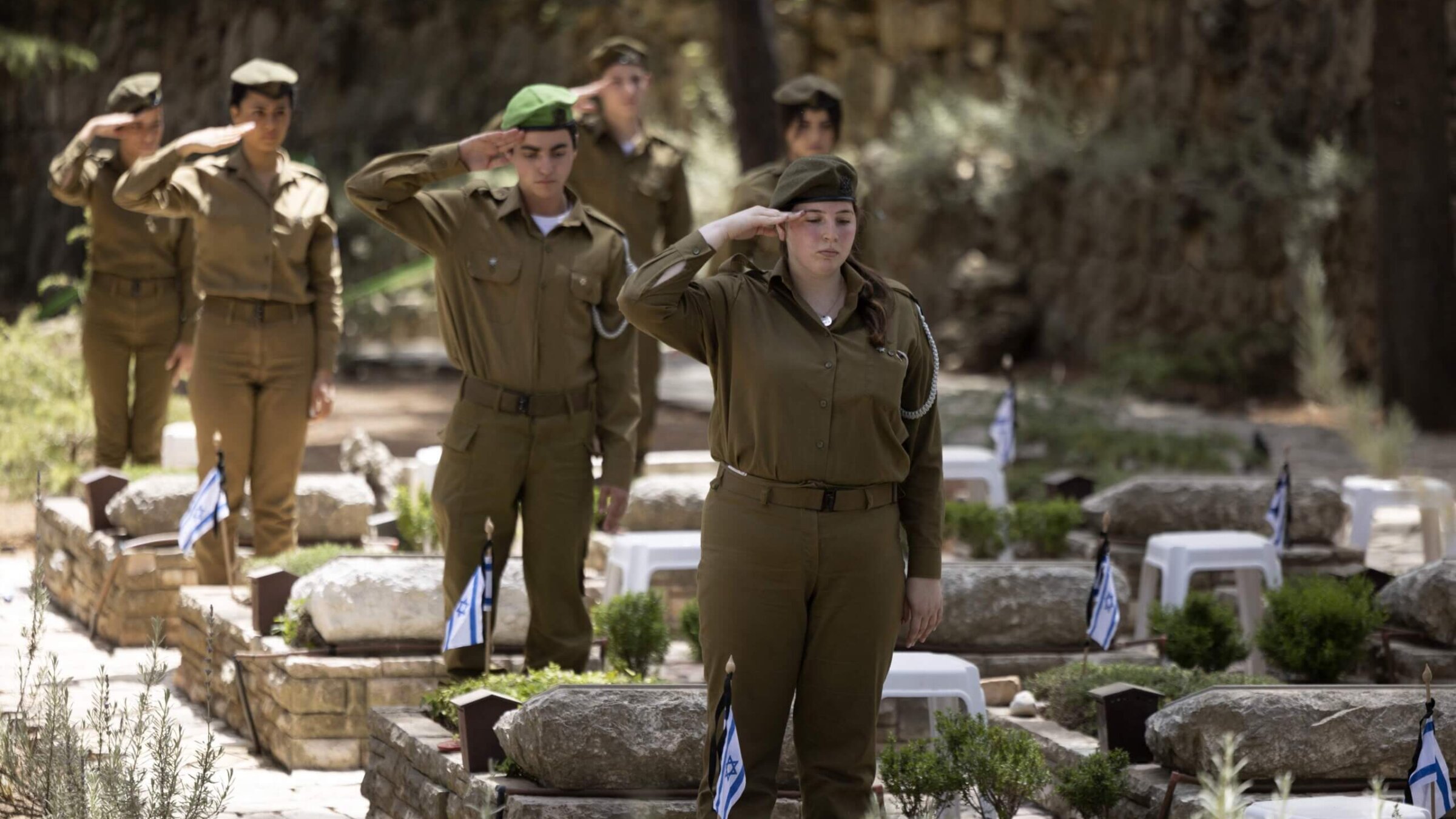 Israeli soldiers pay their respect at the Mount Herzl military cemetery in Jerusalem on May 2, 2022.