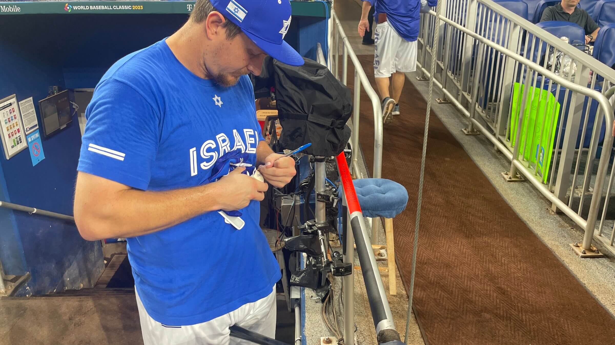 Team Israel outfielder Alex Dickerson signs an autograph at the World Baseball Classic.