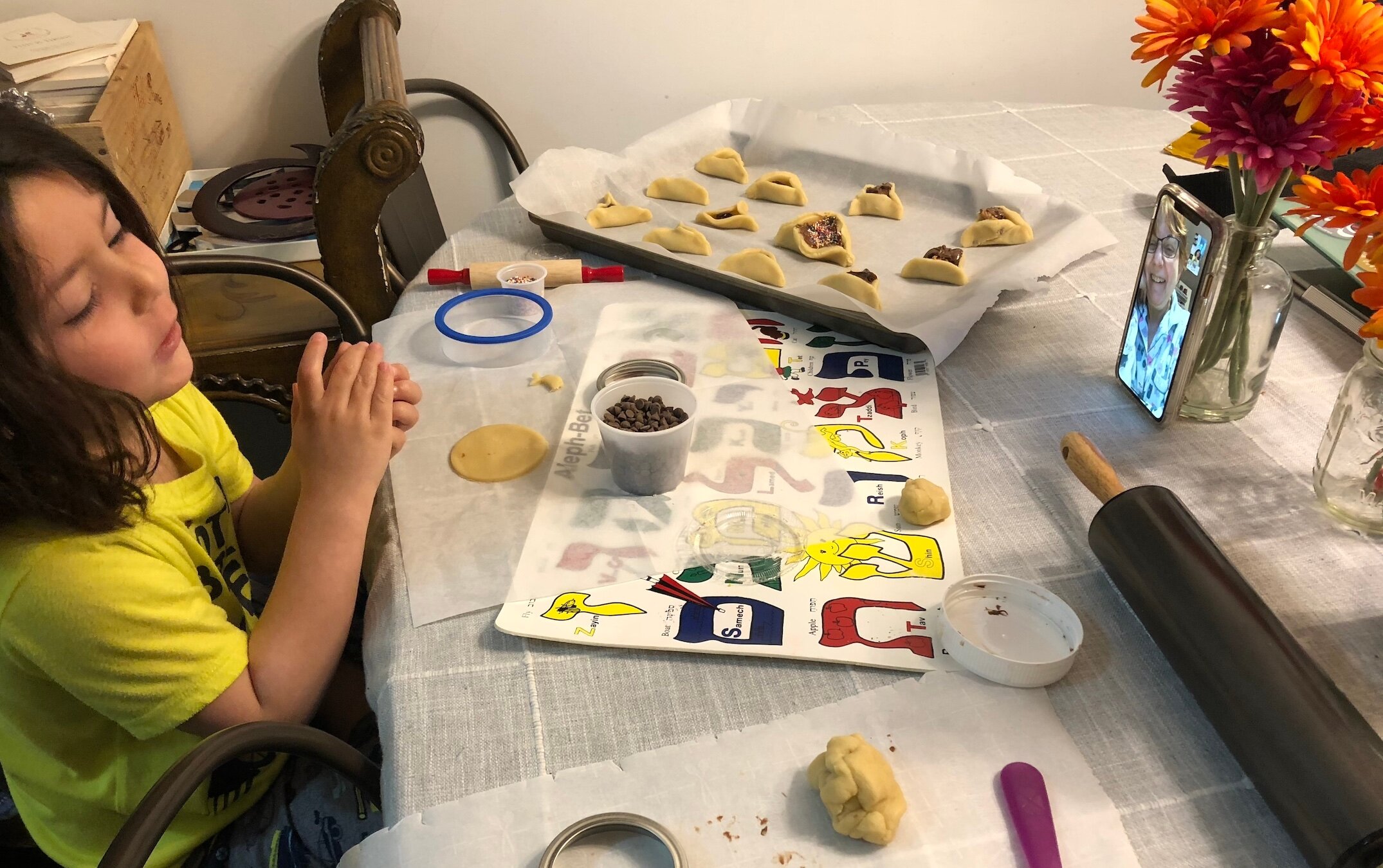 Erin Beser’s son, Aldo, makes hamantaschen with his grandmother Kay Beser on FaceTime. (Courtesy Erin Beser)