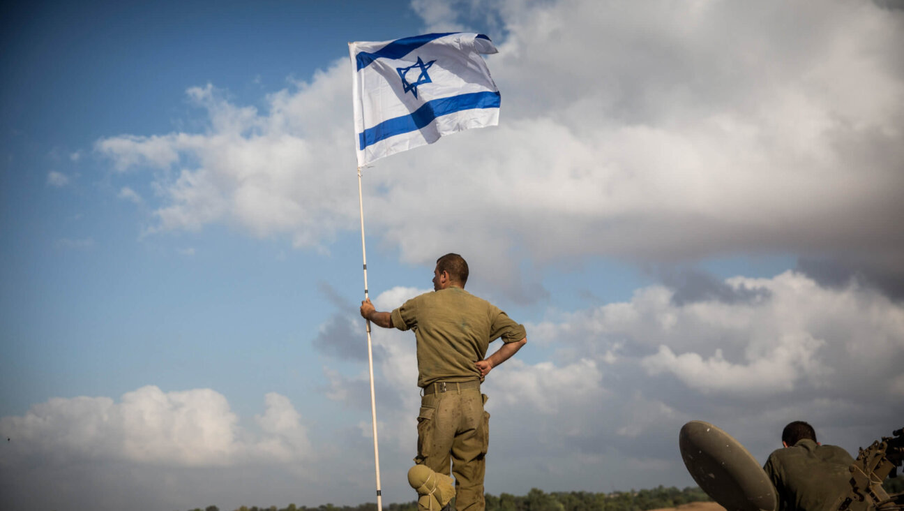 An Israeli soldier stands on top of an armored personnel carrier near the Israeli-Gaza border on July 15, 2014 near Sderot, Israel.  