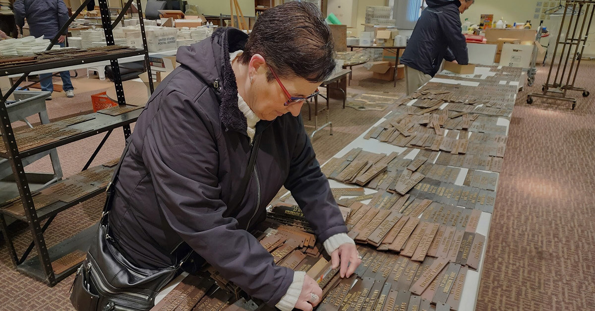 Stephanie Davis searches for yahrzeit plaques bearing her grandparents' names.