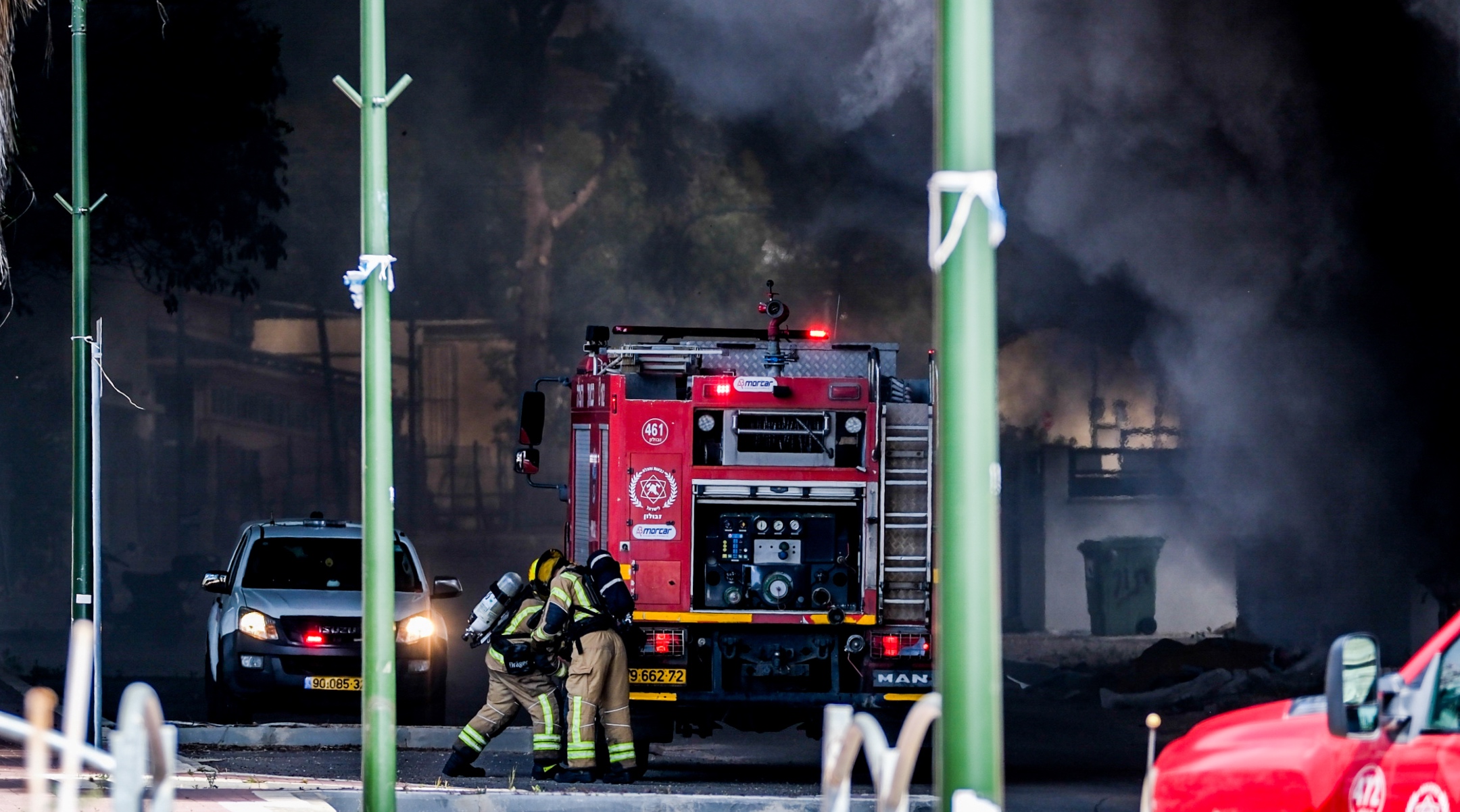 Firefighters try to extinguish a fire caused after a rocket sent from Lebanon hit near the Israeli town of Shlomi, April 6, 2023. (Fadi Amun/Flash90)