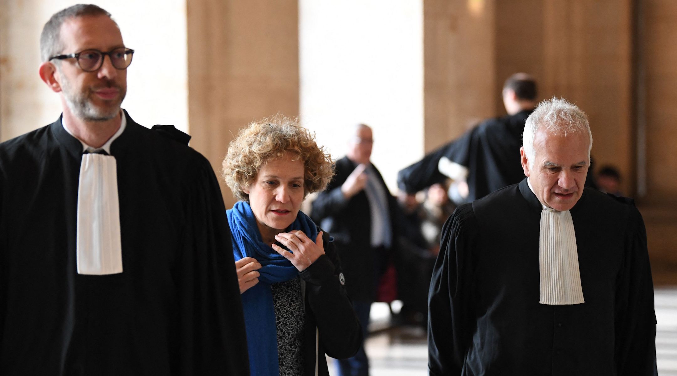 Corinne Adler, a victim who was 13 at the time of the Rue Copernic synagogue bombing, shown with lawyers at the Palais de Justice courthouse in Paris, April 3, 2023. (Bertrand Guay/AFP via Getty Images)