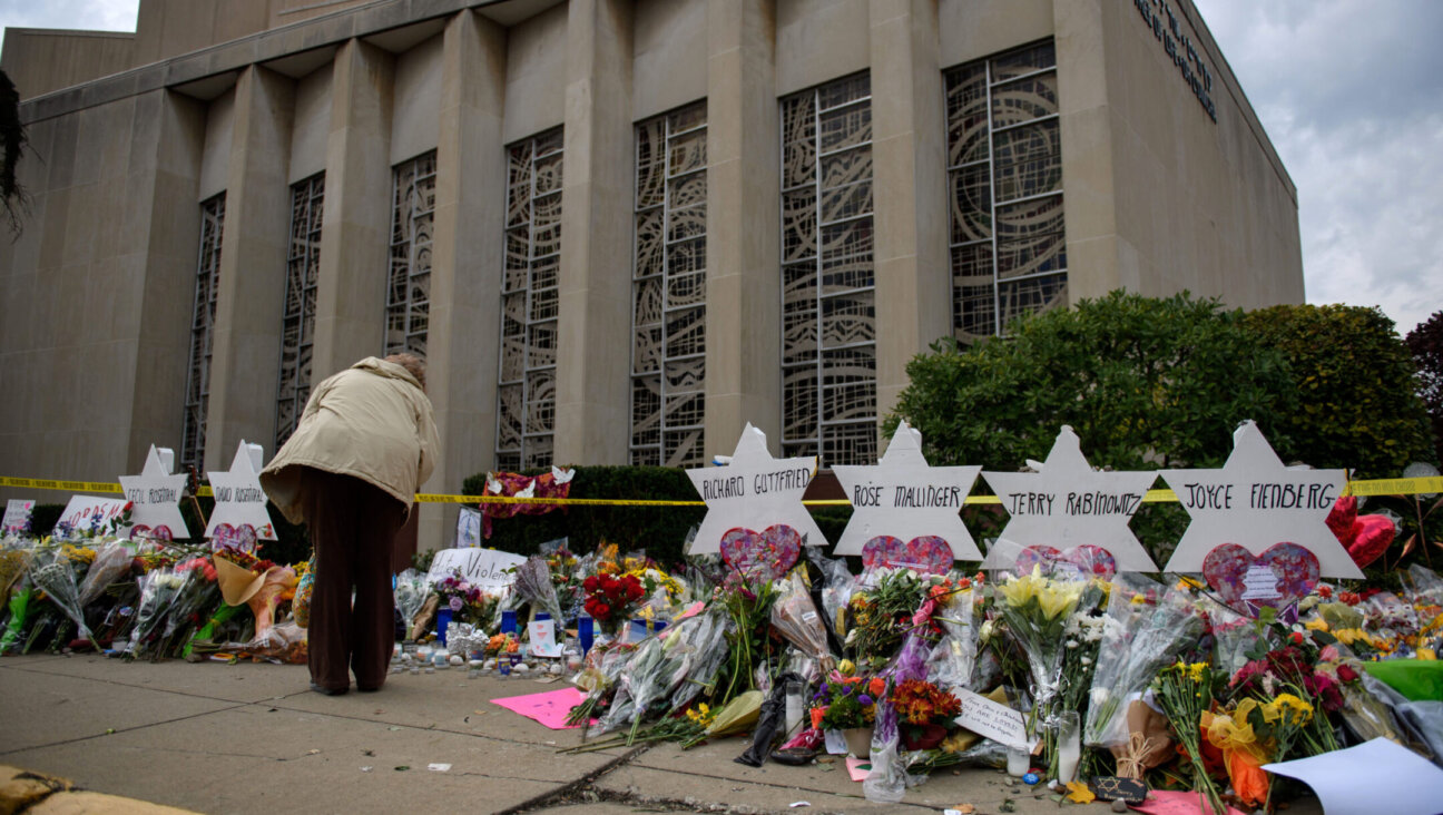 Mourners visit the memorial outside the Tree of Life Synagogue, Oct. 31, 2018 in Pittsburgh, Pennsylvania, four days after 11 Jewish worshippers were killed during services there. The alleged shooter’s trial begins April 24, 2023. (Jeff Swensen/Getty Images)