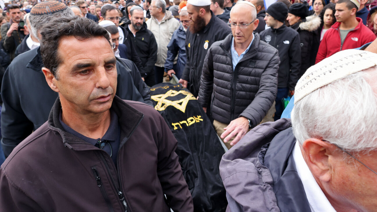 Mourners carry the body of Lucy Dee, 45, a British-Israeli woman who died of her injuries three days after a suspected Palestinian gun attack, in which two of her daughters were also killed.