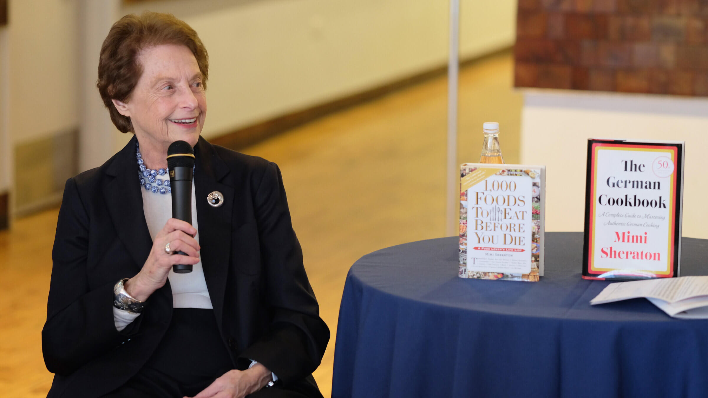 Mimi Sheraton with two of her books on display in 2016 in New York.