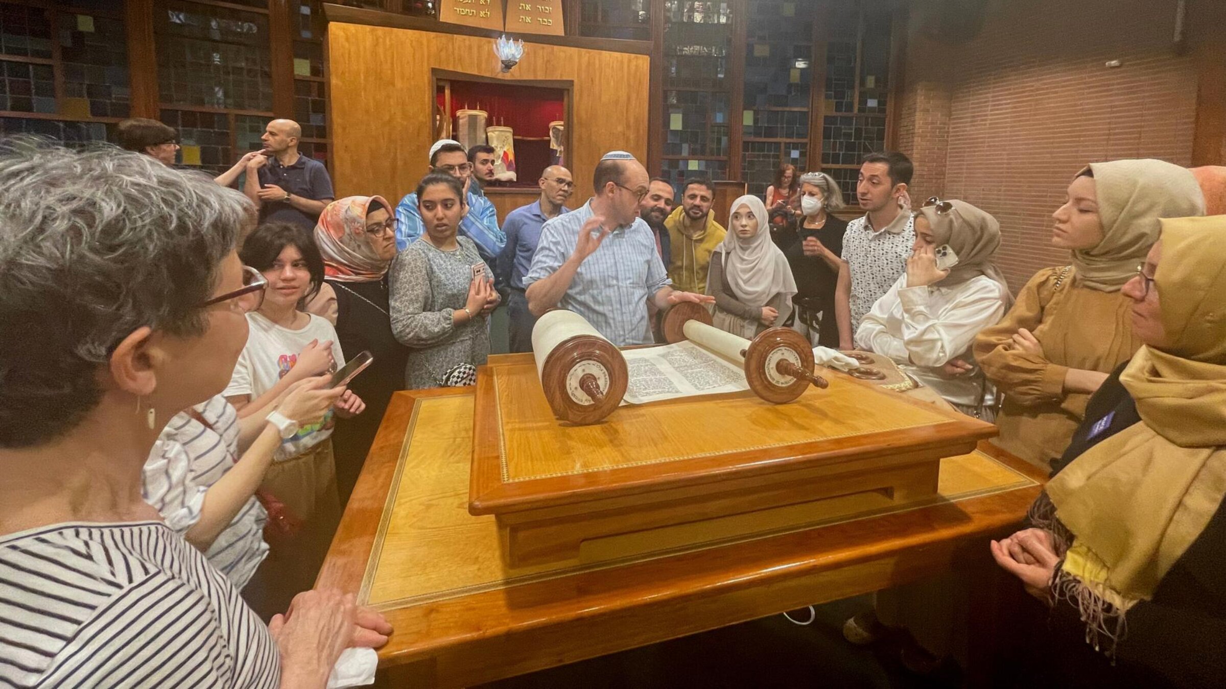 After dinner and kaddish, Rabbi Marc Katz showed our Muslim guests the synagogue’s new Torah. 