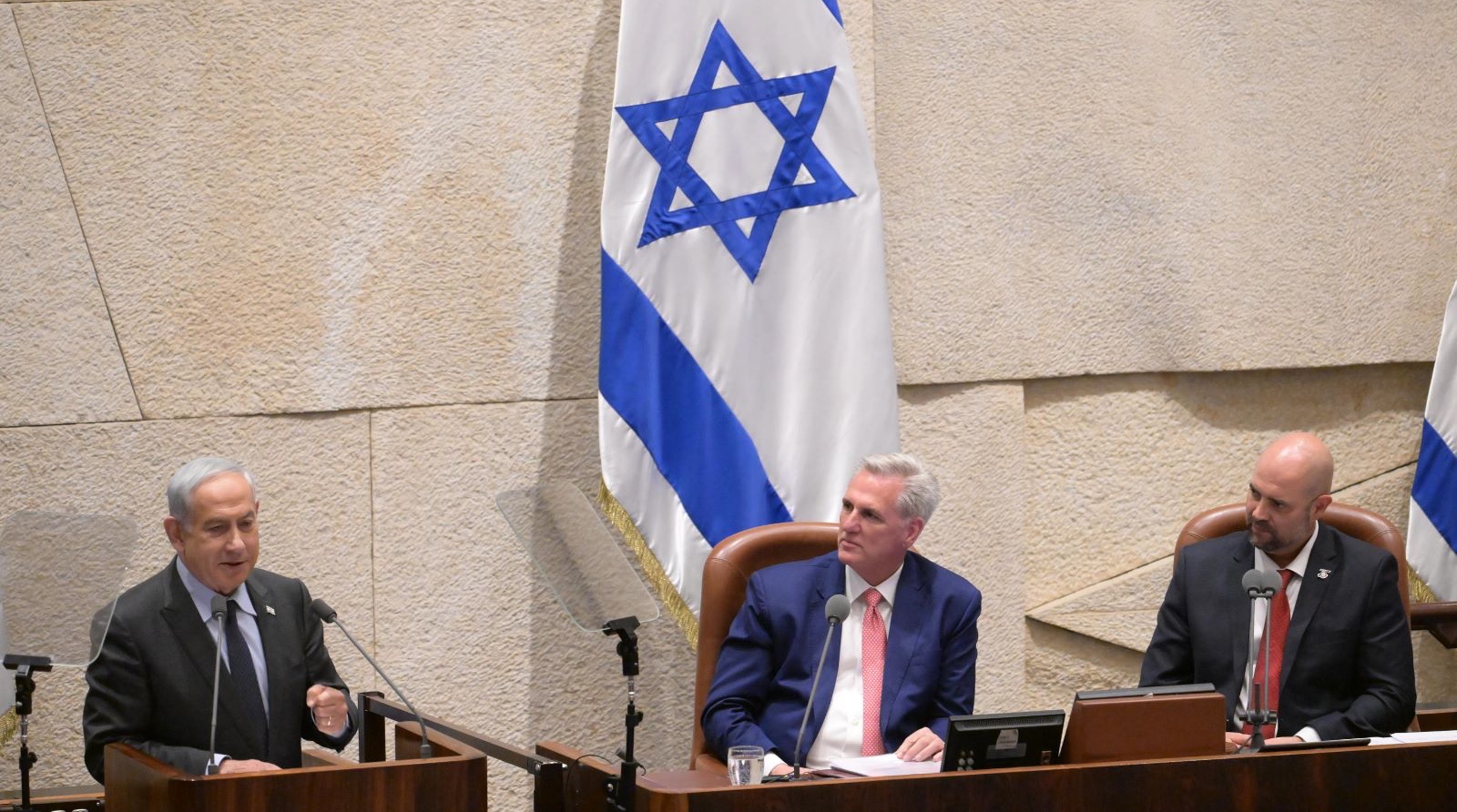 Israeli Prime Minister Benjamin Netanyahu left, speaks to the Knesset while Rep. Kevin McCarthy, the U.S. House of Representatives Speaker, center, and Amir Ohana, the Knesset speaker, look on in the Knesset in Jerusalem, May 1, 2023. (Amos Ben-Gershom, Israel Government Press Office.)