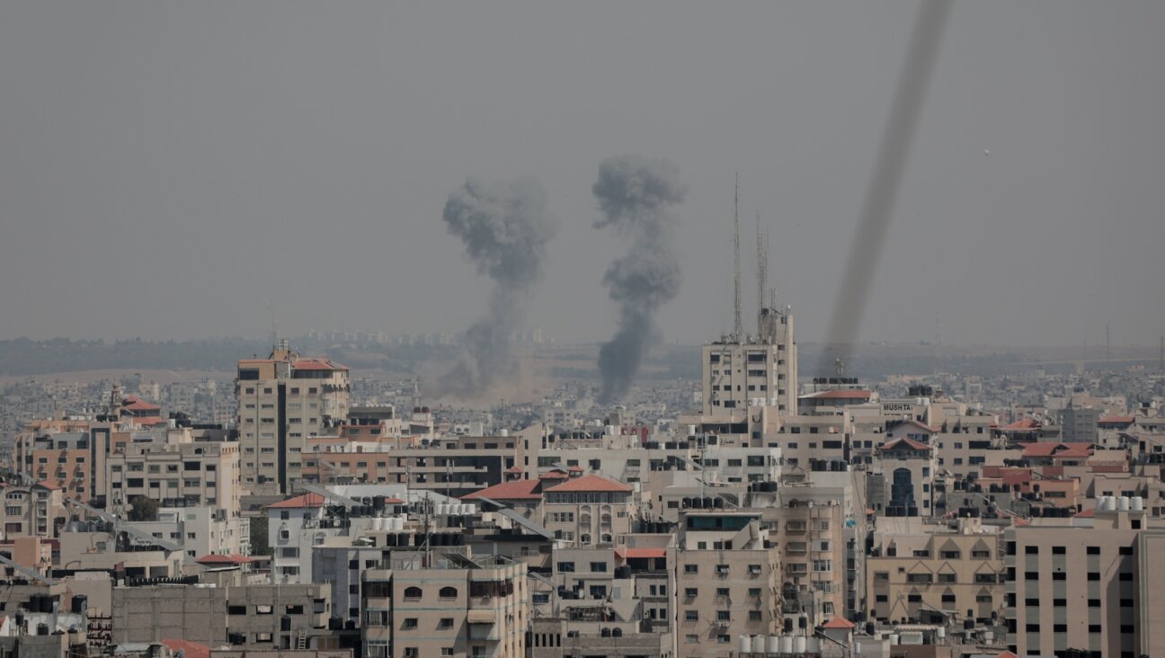 Smoke rises above buildings after air strikes by Israeli warplanes in Gaza City, May 10, 2023. (Atia Mohammed/Flash90)