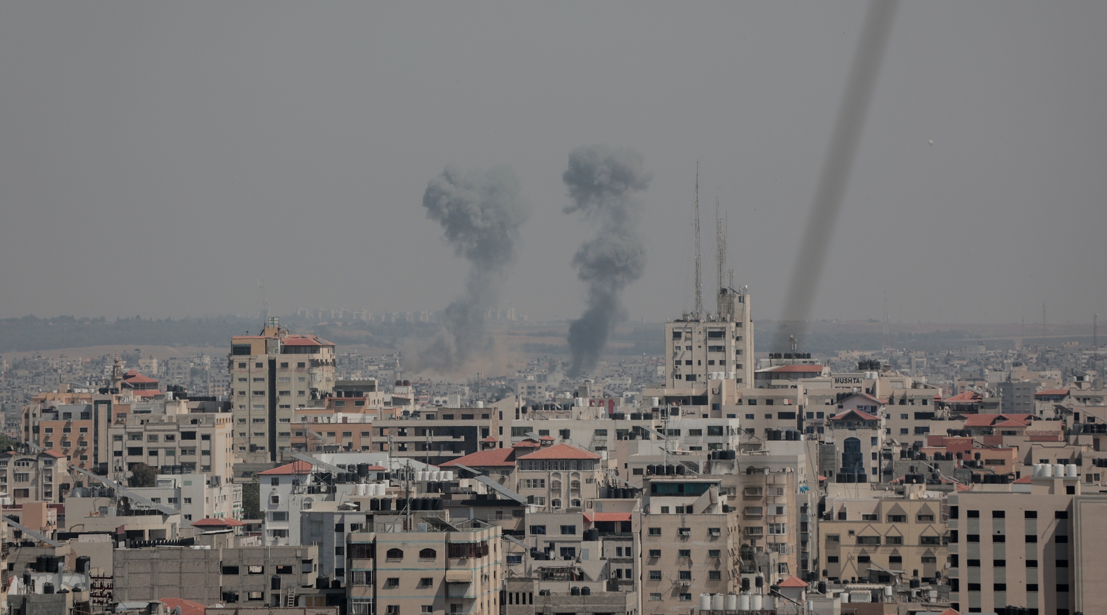 Smoke rises above buildings after air strikes by Israeli warplanes in Gaza City, May 10, 2023. (Atia Mohammed/Flash90)