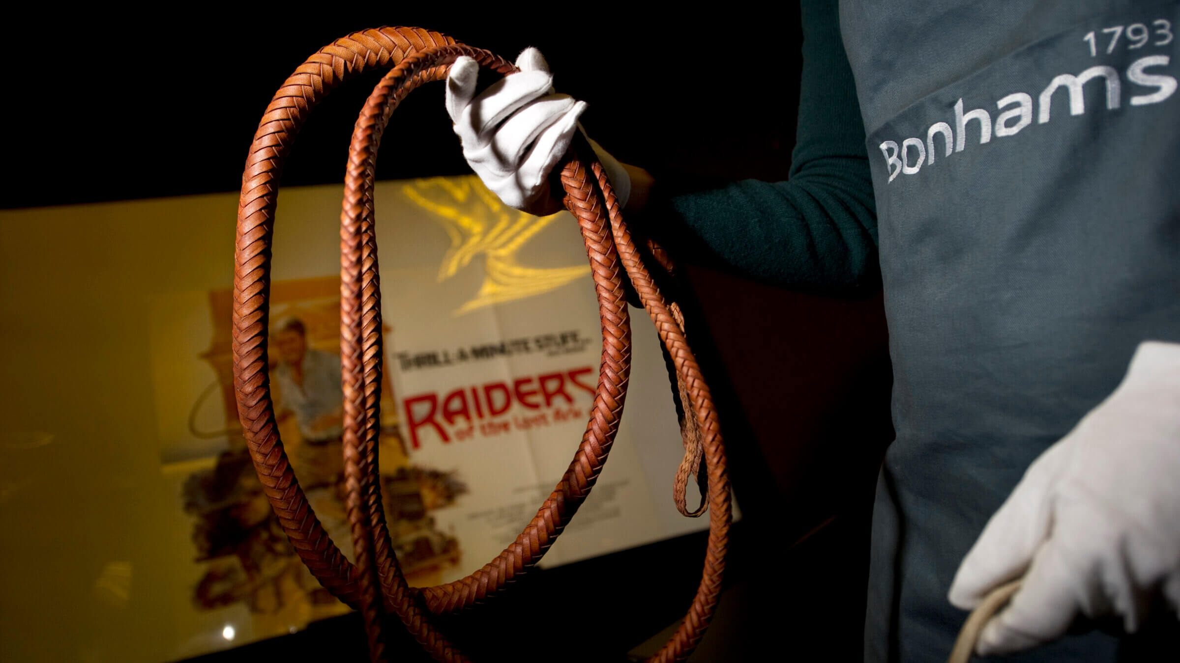 A Bonham's employee holds the bullwhip used by Harrison Ford as Indiana Jones.