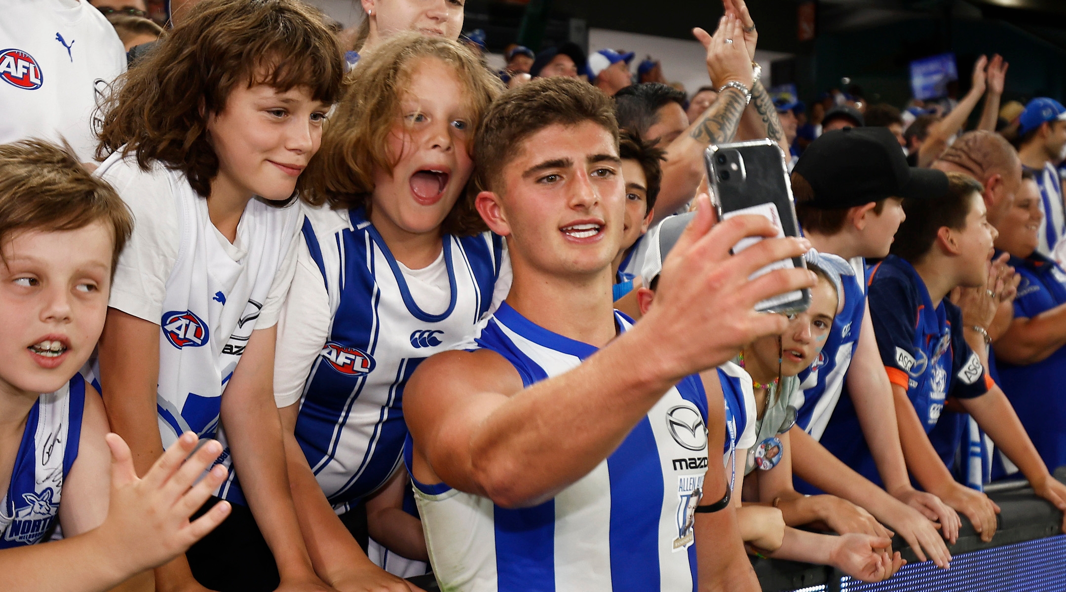 Harry Sheezel celebrates with Melbourne Kangaroos fans at Marvel Stadium in Melbourne, March 18, 2023. (Daniel Pockett/Getty Images)