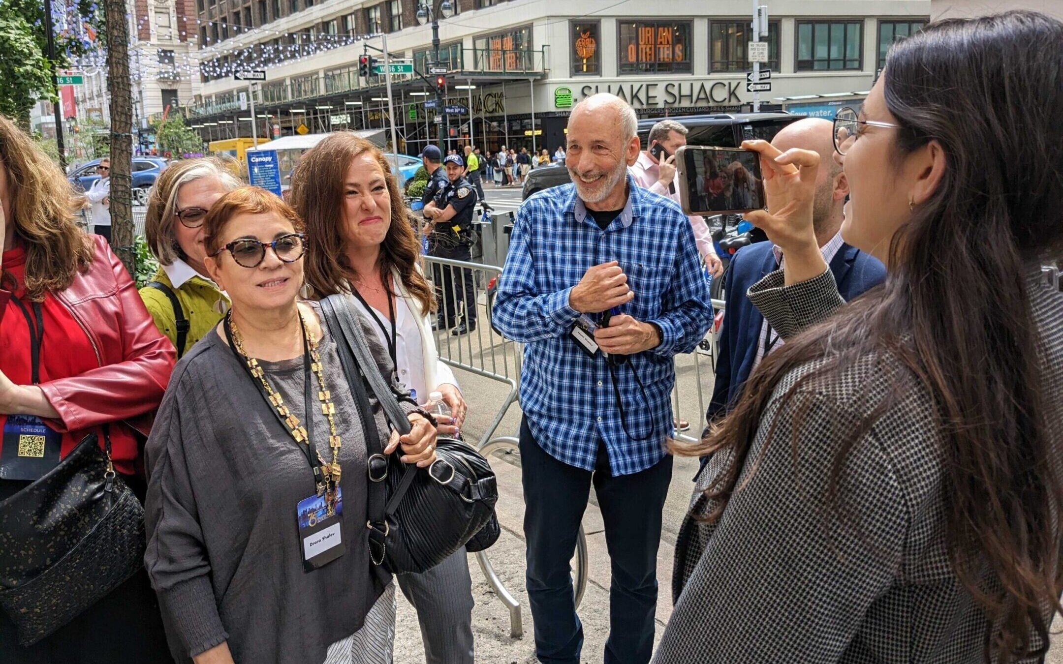 Anti-government protesters are filmed by UnXeptable activist Shany Granot-Lubaton after being ejected from the Jerusalem Post conference in New York City, June 5, 2023. (Ben Sales)