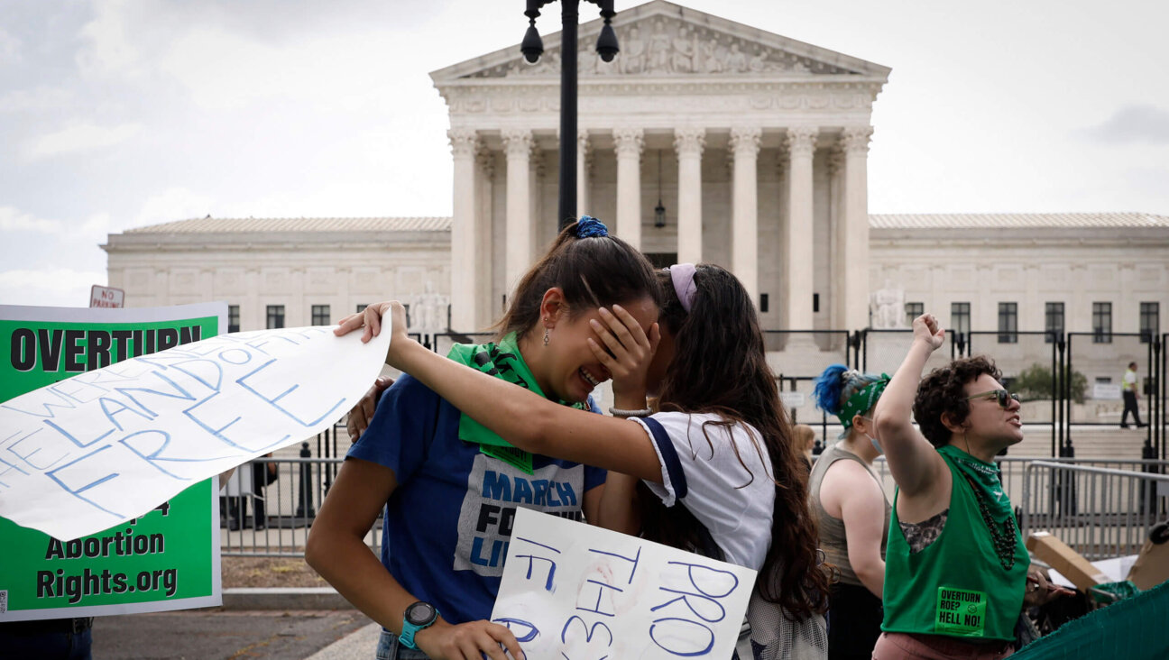 Abortion rights activists Carrie McDonald  (L) and Soraya Bata react to the Dobbs v Jackson Women’s Health Organization ruling which overturns the landmark abortion Roe v. Wade case in front of the U.S. Supreme Court on June 24, 2022 in Washington, DC.   