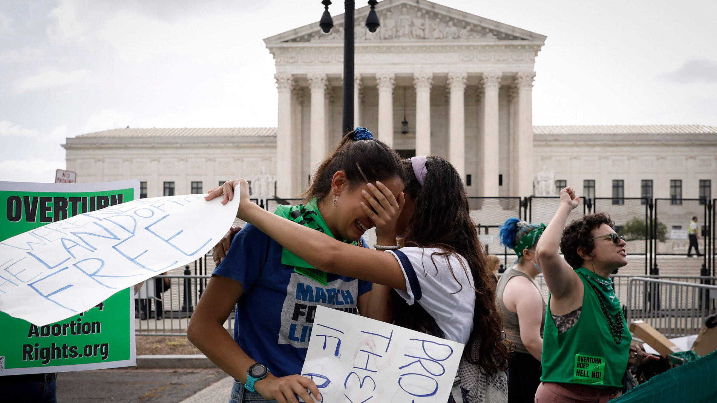 Abortion rights activists Carrie McDonald  (L) and Soraya Bata react to the Dobbs v Jackson Women’s Health Organization ruling which overturns the landmark abortion Roe v. Wade case in front of the U.S. Supreme Court on June 24, 2022 in Washington, DC.   