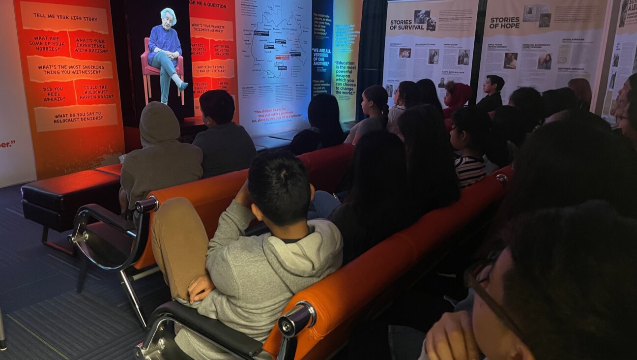 Students talk to a Holocaust survivor in the <i>We are White Plains</i> exhibit.