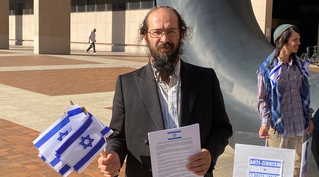 Alexander Popivker protests outside the Cleveland Justice Center, where he faced sentencing for stealing a Palestinian group’s banner at Cleveland State University, July 19, 2023. (Courtesy of Alexander Popivker)