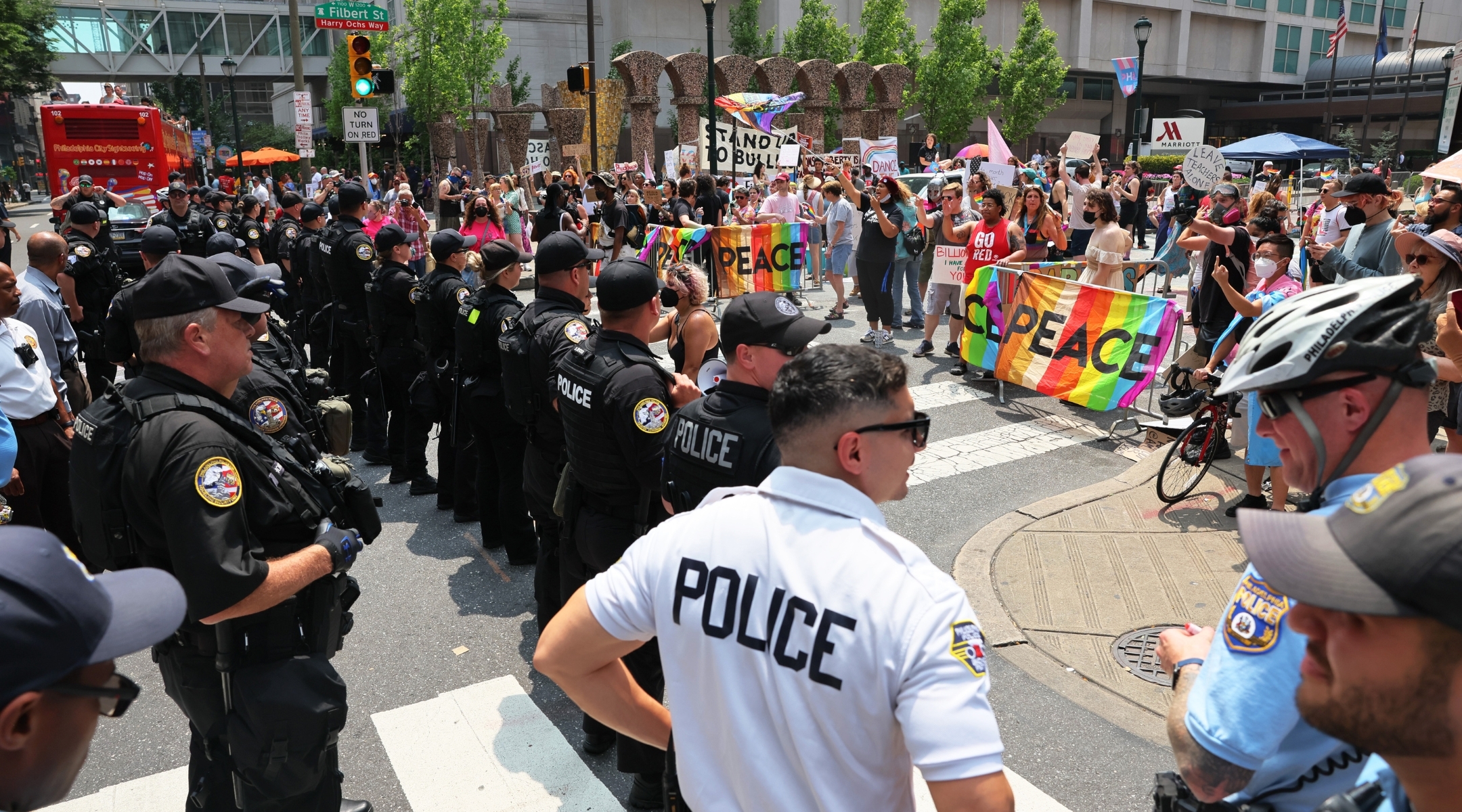 Police and protestors stand outside the Marriott Philadelphia Downtown during the Moms for Liberty summitt. (Michael M. Santiago via Getty Images)