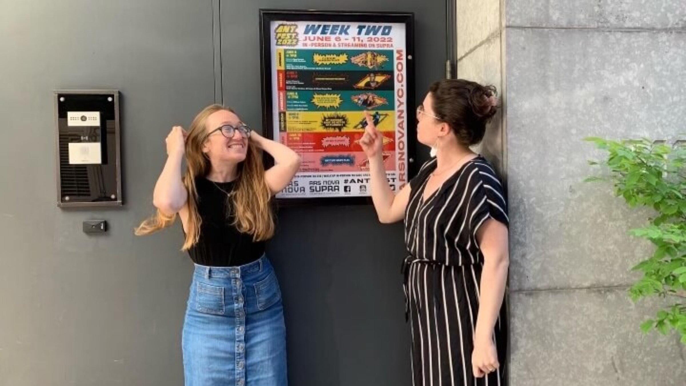 Derman, left, with friend Molly Rosa Houlahan, in front of a poster for one of Derman's plays.