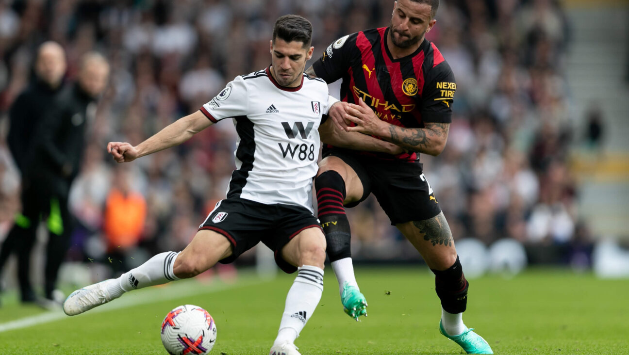 Manor Solomon (left) s challenged by Kyle Walker during an April Premier League match. 