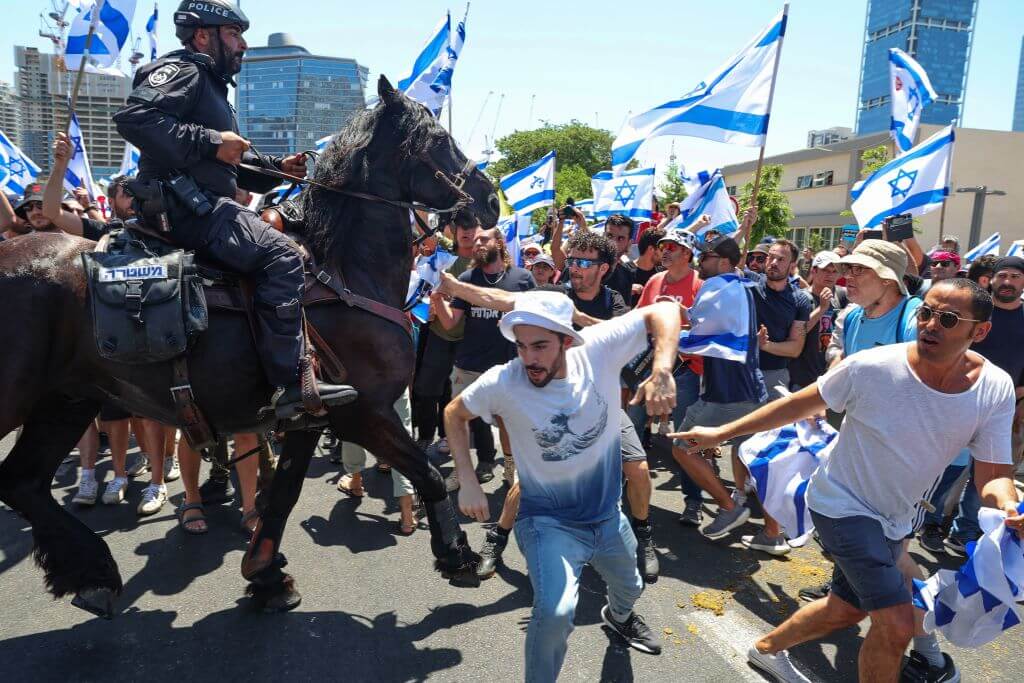 Members of Israel's mounted police move to disperse a protest in Tel Aviv on July 11, 2023, after the Knesset advanced a portion of the judicial overhaul bill.