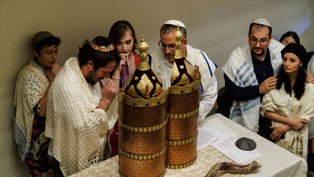 During the first b'nai mitzvah at Tbilisi's  Peace Synagogue, Nina Mgeladze, center, was one of the first women to read Torah in Georgia's 2,600 years of Jewish history. Rabbi Golan Ben-Chorin of Haifa, to her left, ls the nascent congregation's spiritual leader. At right are Misha Grishashvili, the synagogue's founding president, and his wife, Keti Chikviladze, director of Georgia's Hillel, both of whom also became b'nai mitzvah.