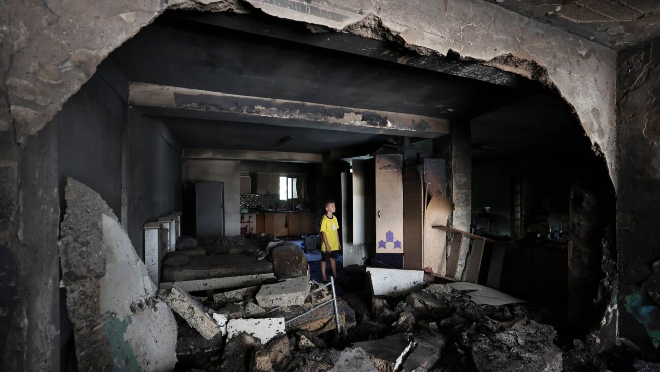 A boy checks the damage inside a house in the occupied West Bank Jenin refugee camp on July 6, 2023, following a large-scale Israeli military operation that lasted for two days. 