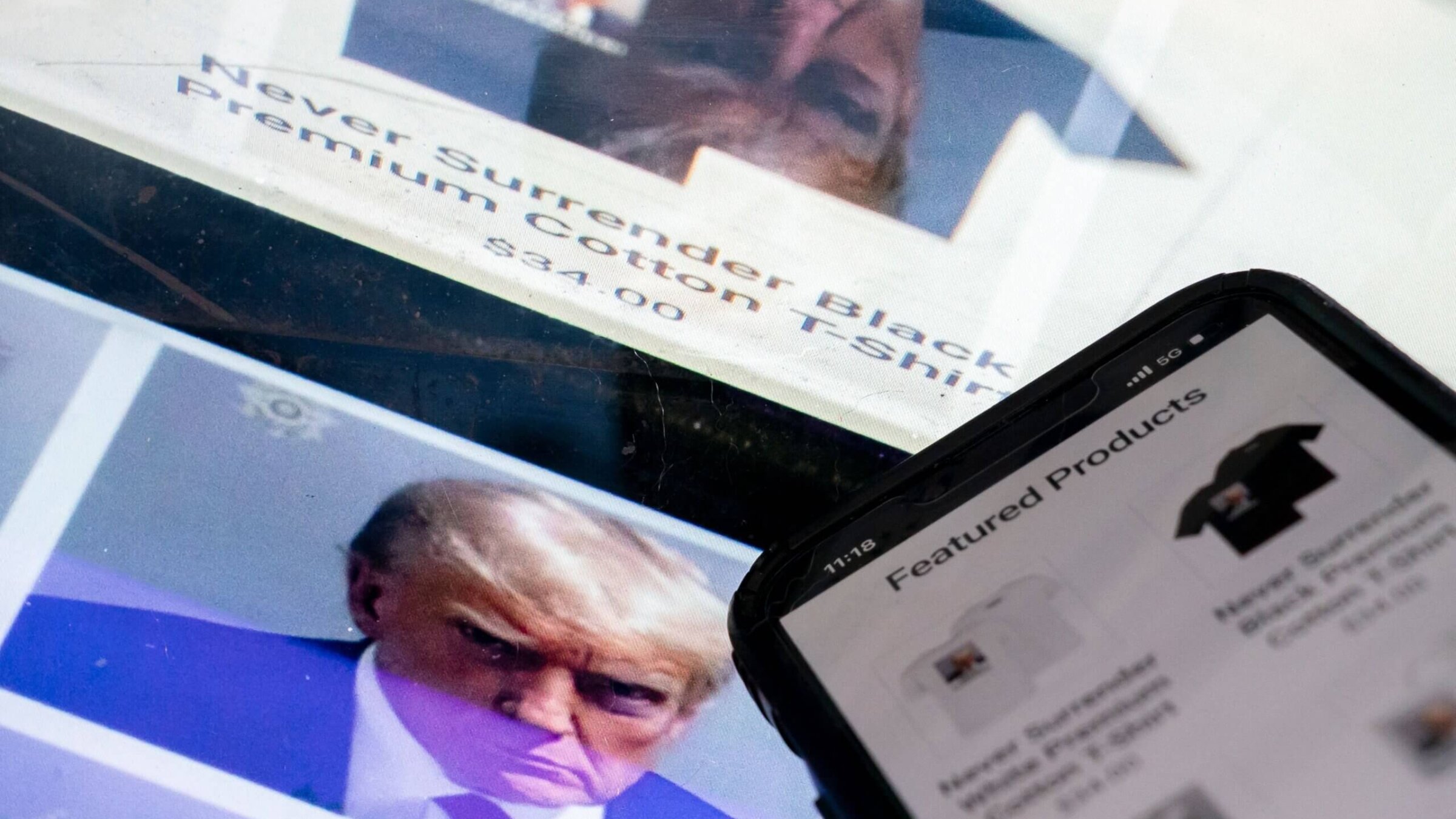 A photo illustration shows the mug shot of former U.S. President Donald Trump next to a website called Trump Save America JFC, a joint fundraising committee on behalf of Donald J. Trump for President 2024, which is selling merchandise bearing his mug shot.