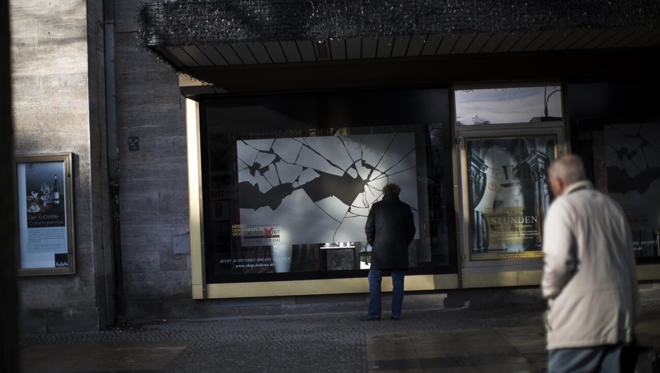 People walk past a Berlin window display commemorating the 75th anniversary of the Kristallnacht pogroms 2013. Germany has won plaudits confronting Nazi crimes, and American officials have turned toward the country for lessons about how to defeat contemporary antisemitism. But some critics sorry that Germany's approach might not be a good fit for the U.S.